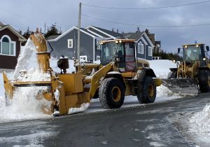 Tractors removing snow from road
